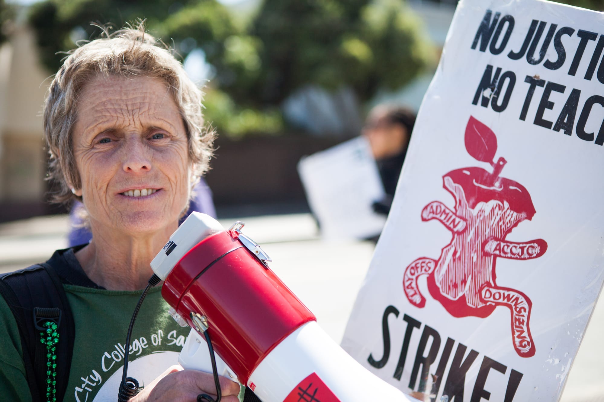 AFT 2121 member Kathe Burick helps lead City College faculty sing and chant while picketing against unfair labor practices at Ocean Campus on April 27, 2016. (Photo by Natasha Dangond/Special to