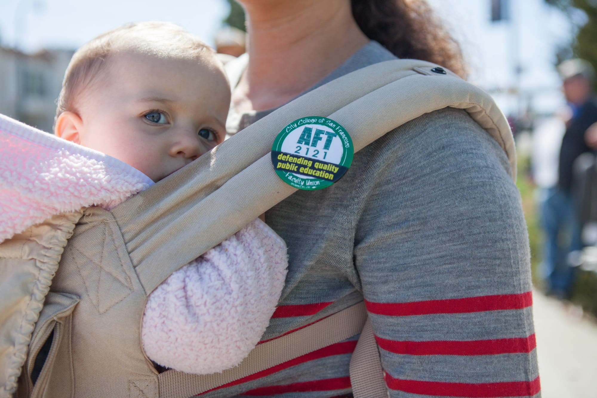 City College English instructor Mitra Sapienza, with her daughter Colette, during a strike against unfair labor practices at Ocean Campus on April 27, 2016. (Photo by Natasha Dangond/Special to The Guardsman)on Wednesday, April 27, 2016. City College of San Francisco Ocean Campus.