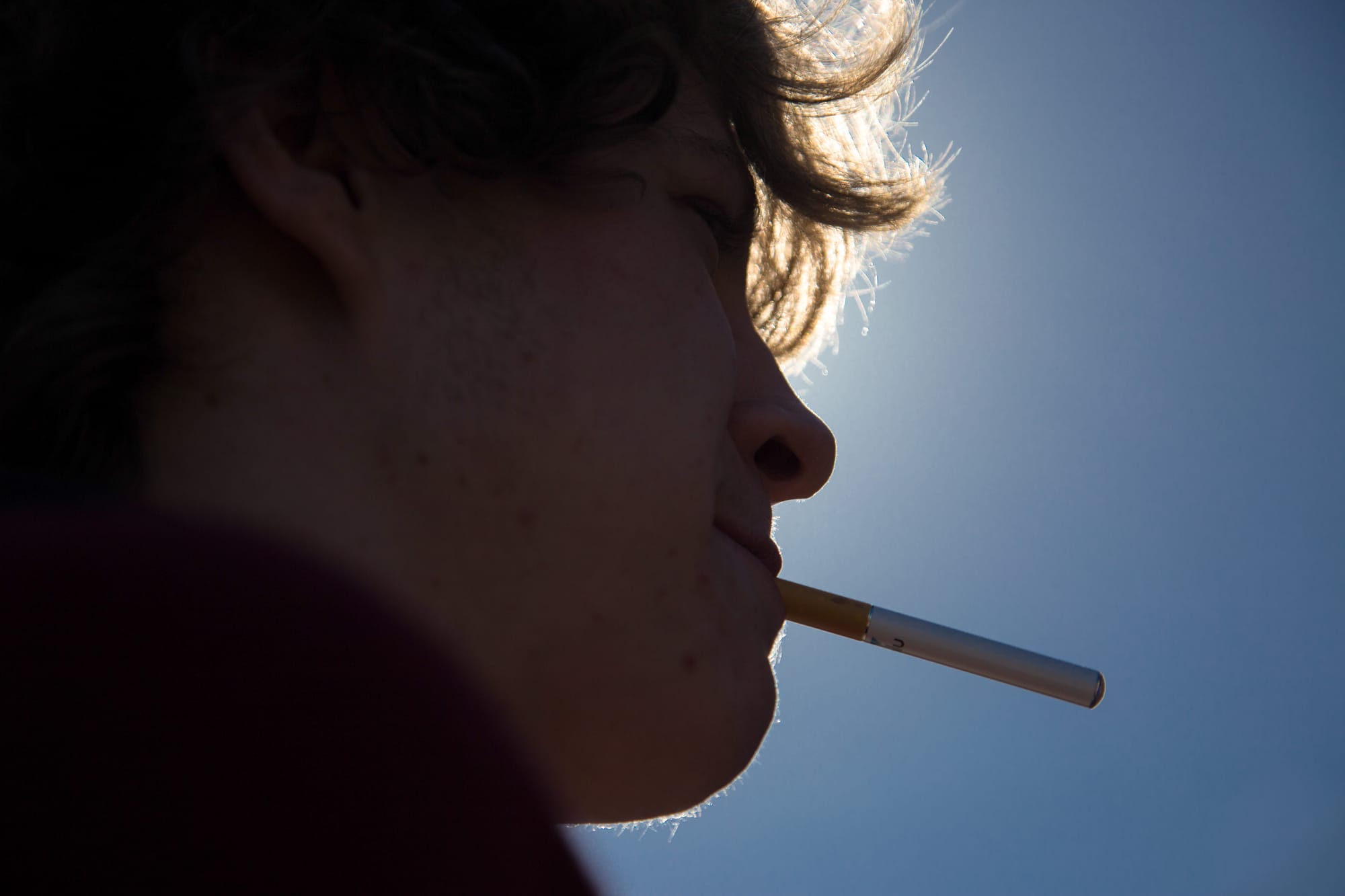 A City College student uses an electronic cigarette after class. A new law would ban smoking on campus, including e-cigs. (2014 file photo by Elisa Parrino/The Guardsman)