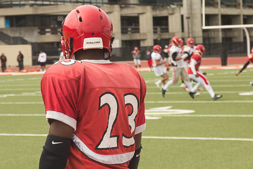 Sophomore defensive back Vince Camp looks on as teammates run drills at George Rush Stadium on Aug. 17, 2016 (Photo by Izar Decleto/The Guardsman)
