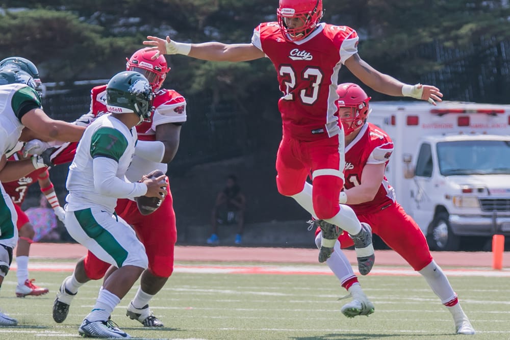 Rams linebackers Jordan Allen (number 23) and Dallas Martin (number 11) rush the Laney quarterback. Photo by Peter Wong. 