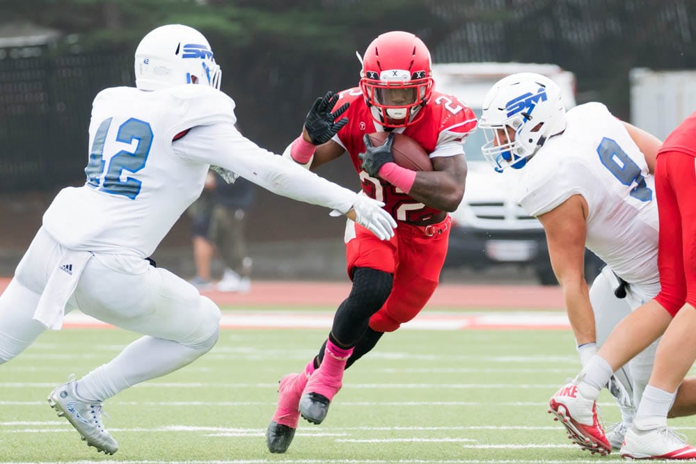 Isaiah Floyd splits between two College of San Mateo defenders. Photo by Peter Wong. 