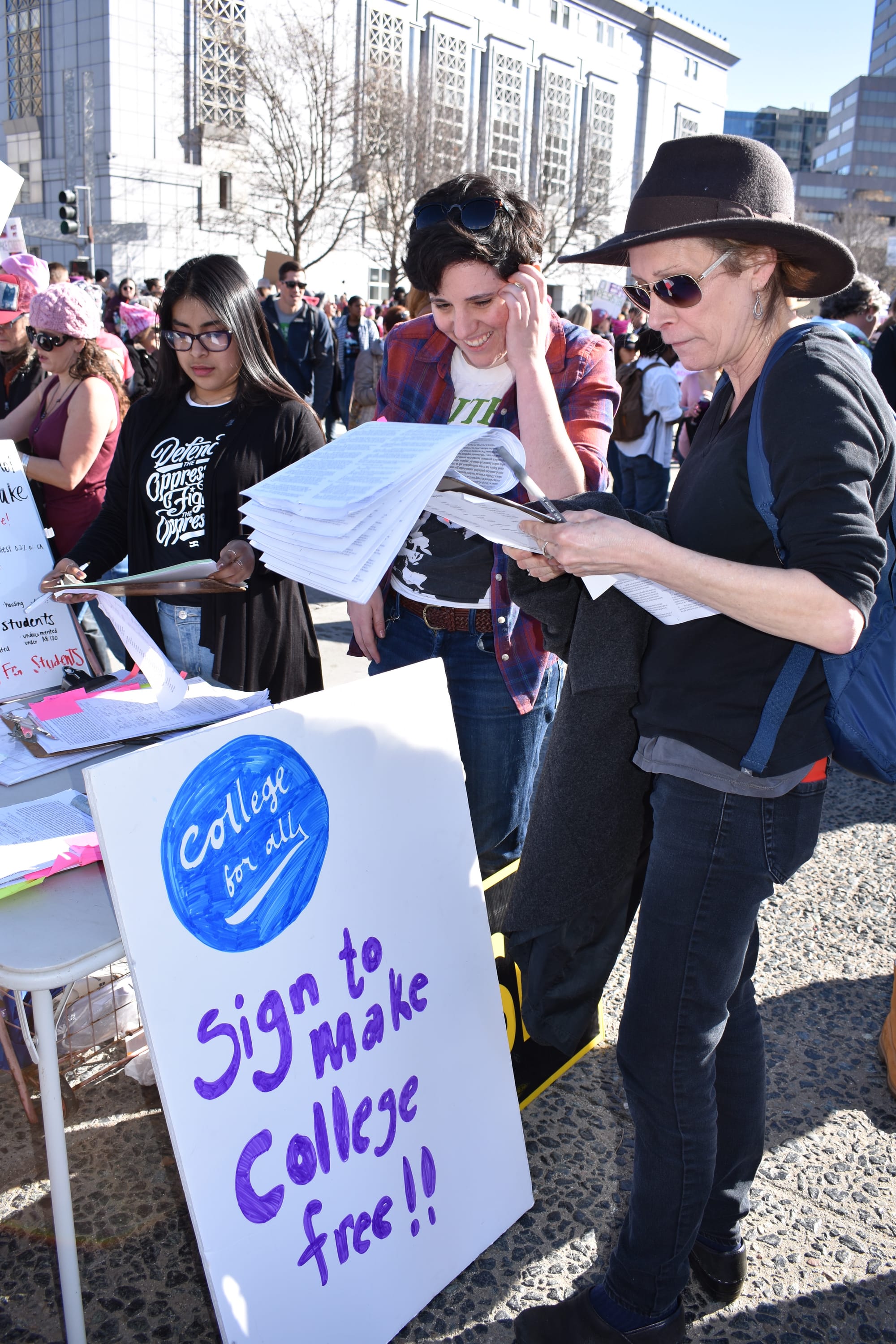 Demonstrators gathering in Civic Center Plaza prepare to protest in the Women's March in San Francisco on Jan. 20, 2018.  Photo by Veronica Steiner/The Guardsman.