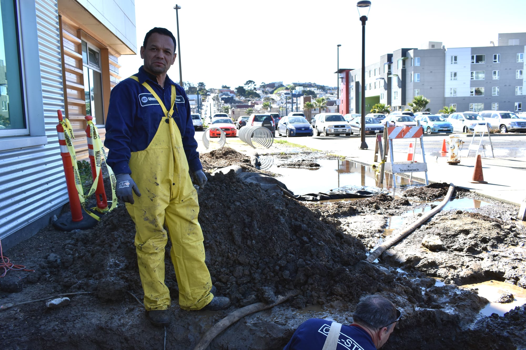 (L-R) ACC Engineering Systems Plumber Jose Lopez and a man who goes by Dave The Plumber finish digging a hole to uncover the source of a water leak at the Ocean Campus Multi-Use Building (MUB) on Feb. 15, 2018. Photo by Michael Menaster/The Guardsman.