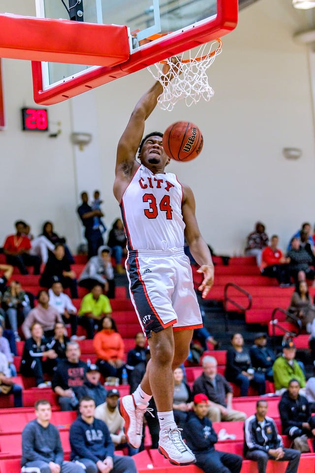 City College Ram's sophomore forward Lewis Hayes (#34) goes up high for a monster one-handed alley-oop dunk against Ohlone College on Feb. 16, 2018. Photo by Eric Sun/special to The Guardsman. 