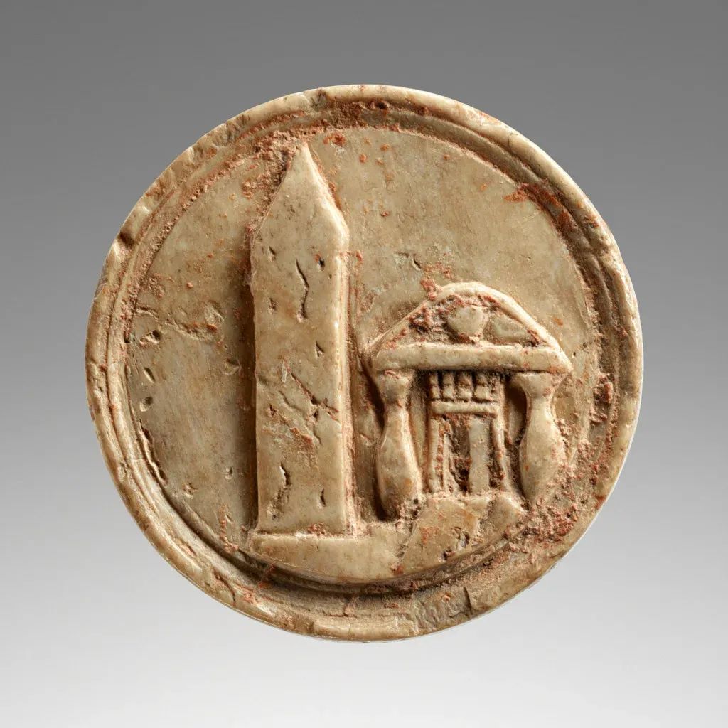 Unknown Artisan, " [Obverse of a] Token with an Egyptian Obelisk [from Nikopolis, Egypt] and a Temple," 1-50 CE, tessera, cattle bone, Roman with Greek inscription on reverse