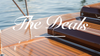 The Deals blog cover image showing a wooden swim platform at the stern of a classic boat, with text overlay explaining how Dock Deals works.