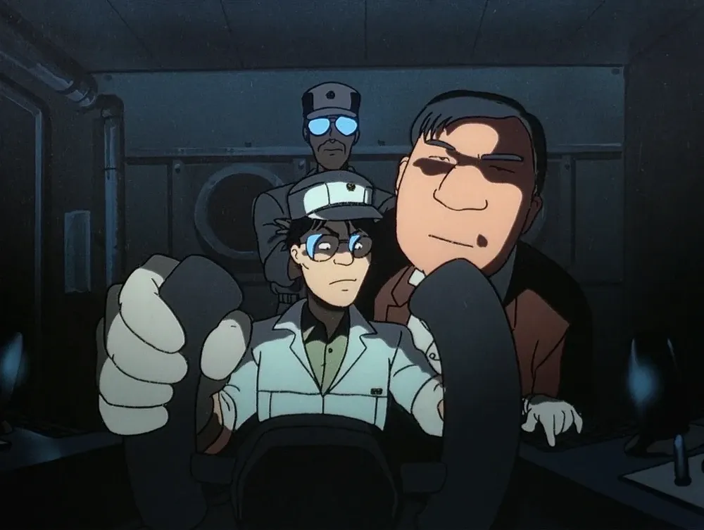 Three men sit behind a steering wheel looking to camera, their faces distorted by a fisheye lens effect.