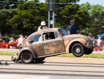 A VW Bug doing a wheelie