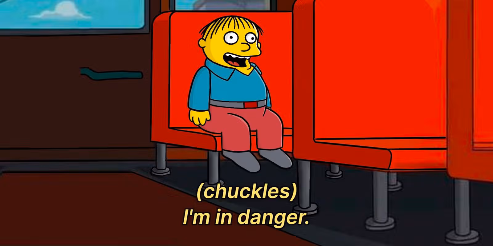 Ralph Wigum sits on a boss laughing
