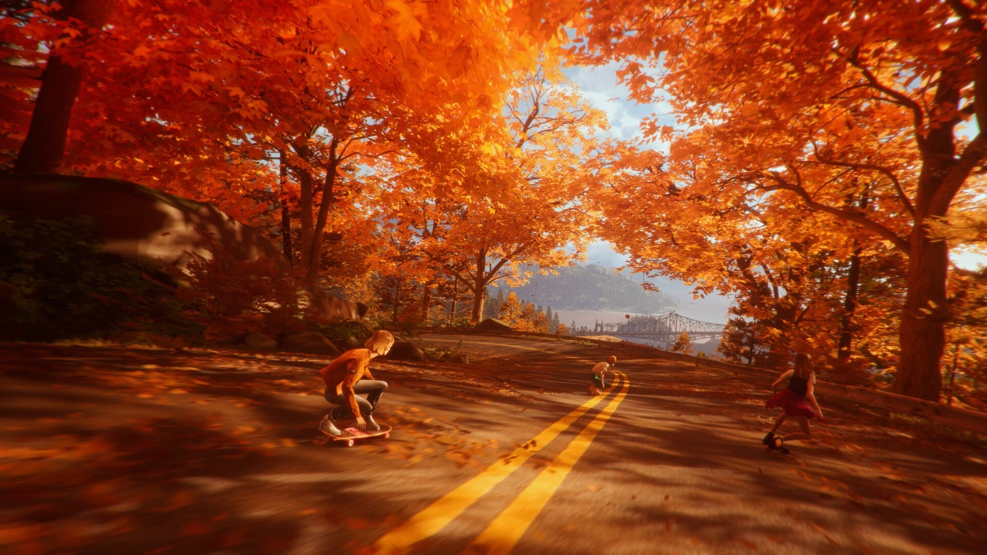 A screenshot of teenagers skateboarding down a road in the Autumn