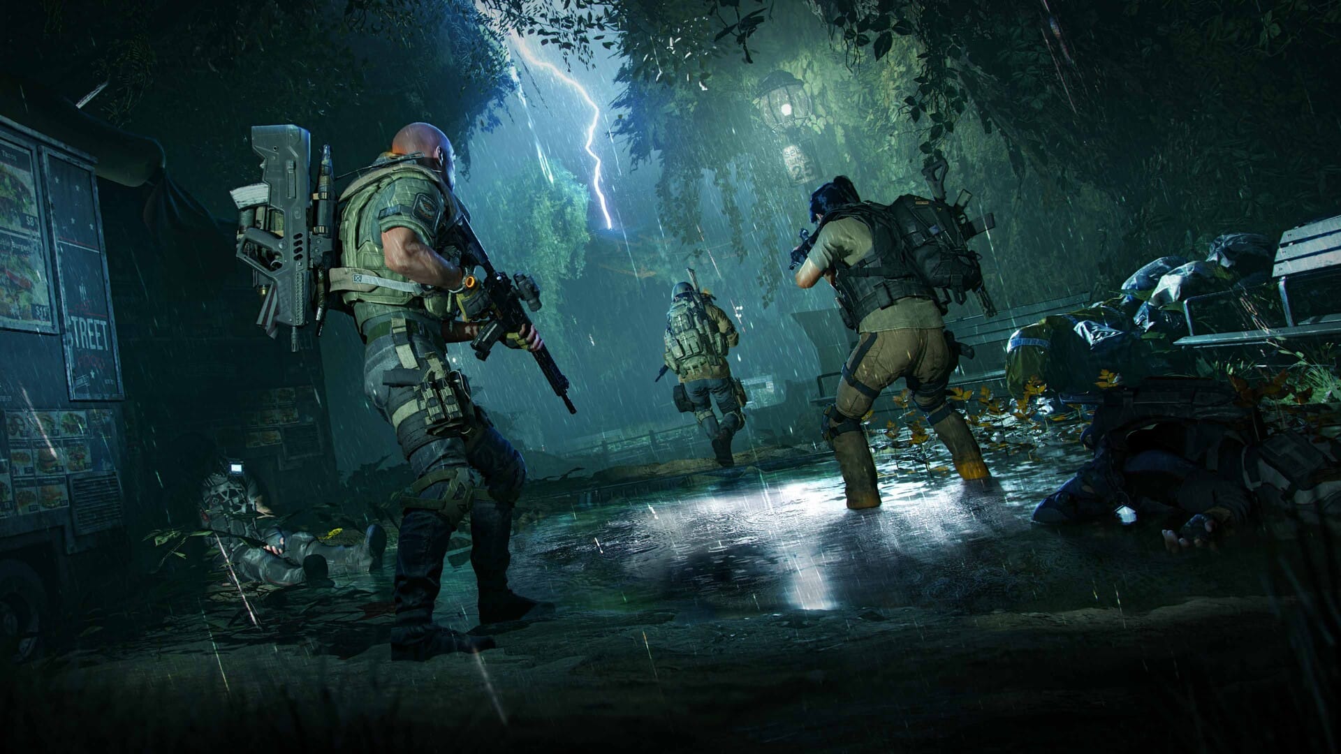A squad of three Divison agents make their way through a city street filled with trees and foliage in the midst of a thunderstorm in a screenshot from The Division 2