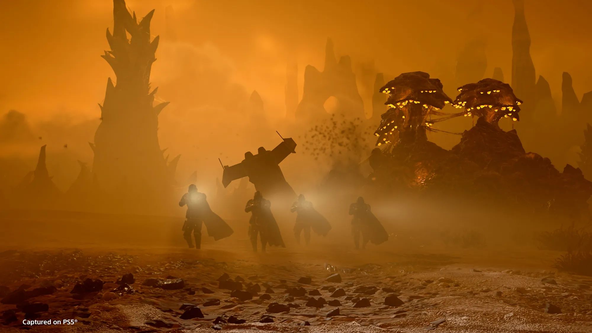 A squad of Helldivers move across Oshaune, with a crashed Pelican and Shrieker Towers visible in the background.