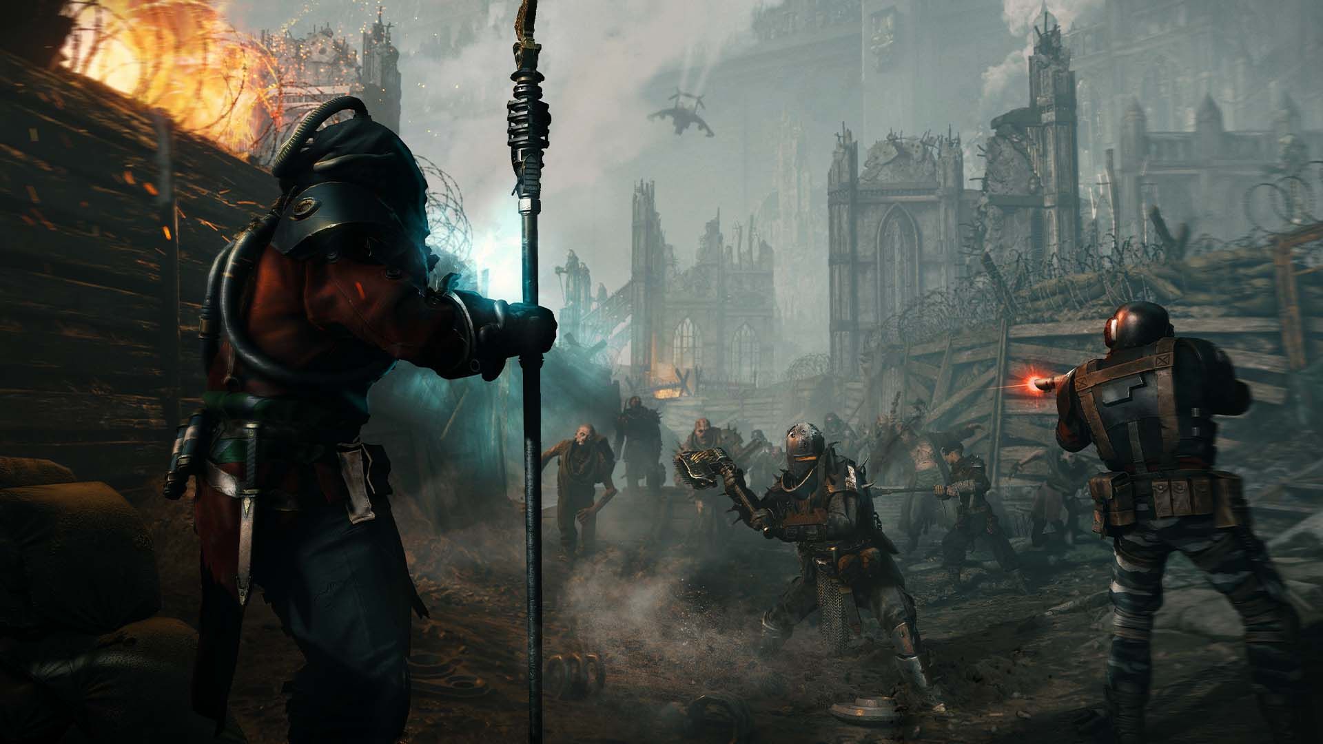 A team of four Rejects work their way through a trench build in the outer ruins of a hive city in a promotional screenshot for Warhammer 40K: Darkti