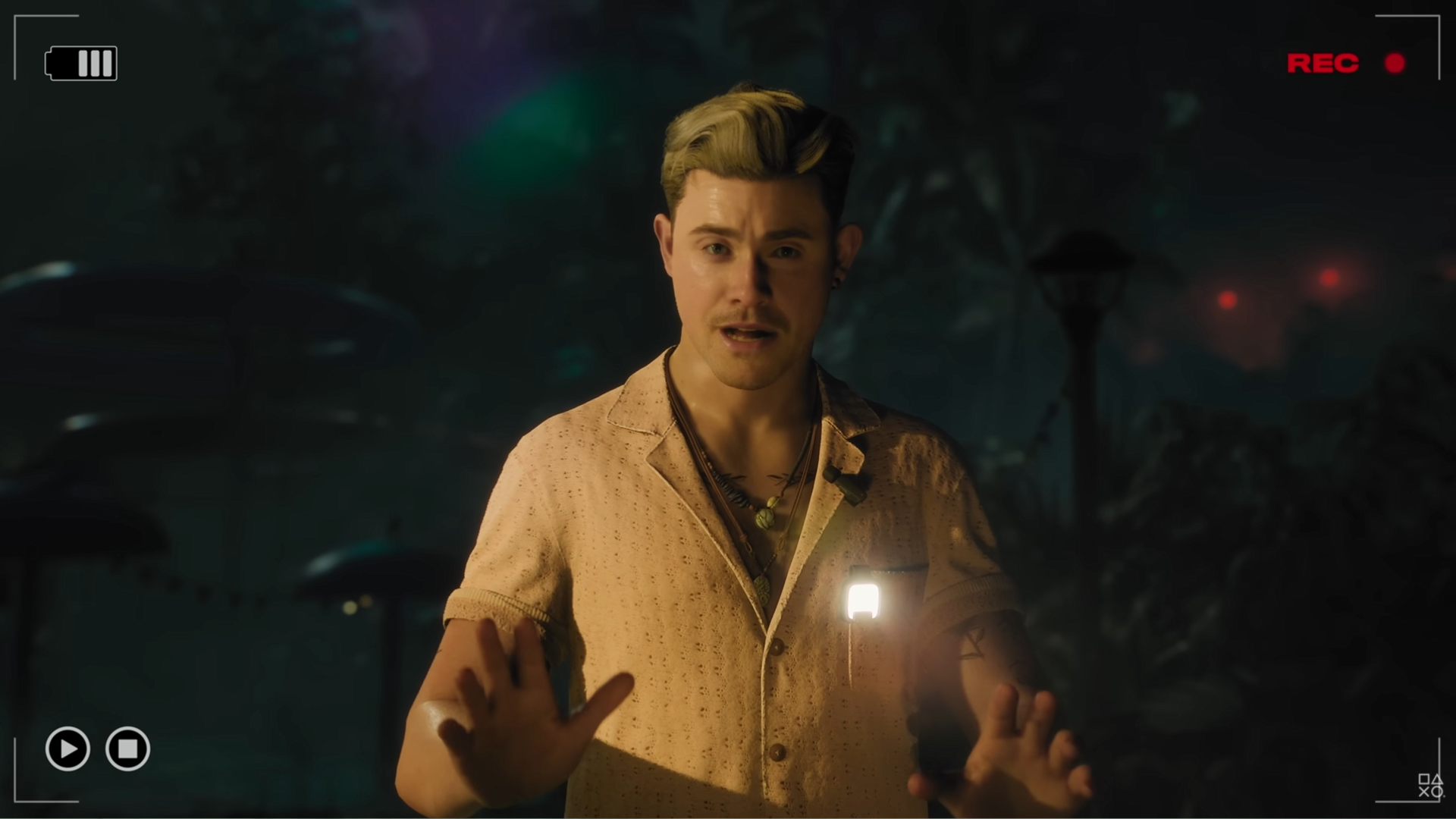 A blond man in a linen shirt is hosting a ghost hunting show on a tropical island in a screenshot from Until Dawn 2