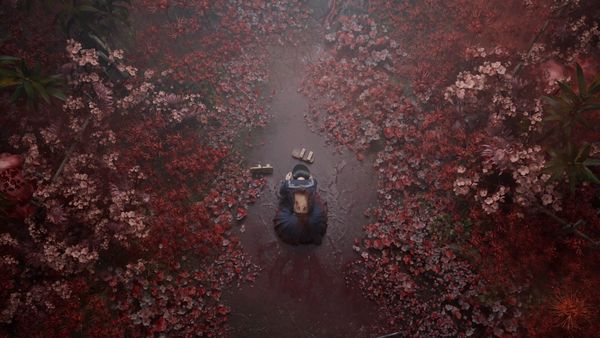 The main character in Silent Hill F collapses to the ground in a field of flowers