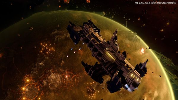 An Imperial Navy vessel stays in space above a contested planet, striking a sprawling Hive City from orbit, in a pre-alpha screenshot from Total War: Warhammer 40K