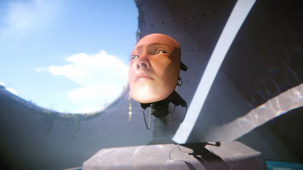 A mask of a human face attached to a robotic apparatus, looking up through the concrete ceiling's circular opening towards a patch of blue sky