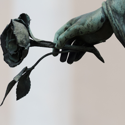 Stone memorial rose in effigy stone hand