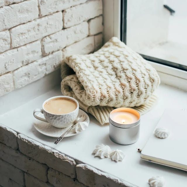 Blanket and candle in a window