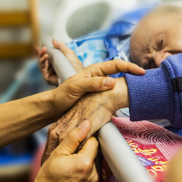 Caregiver and patient in the final moments of biological life. 