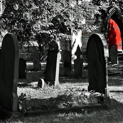 Memorial headstones in a crowded cemetary. 