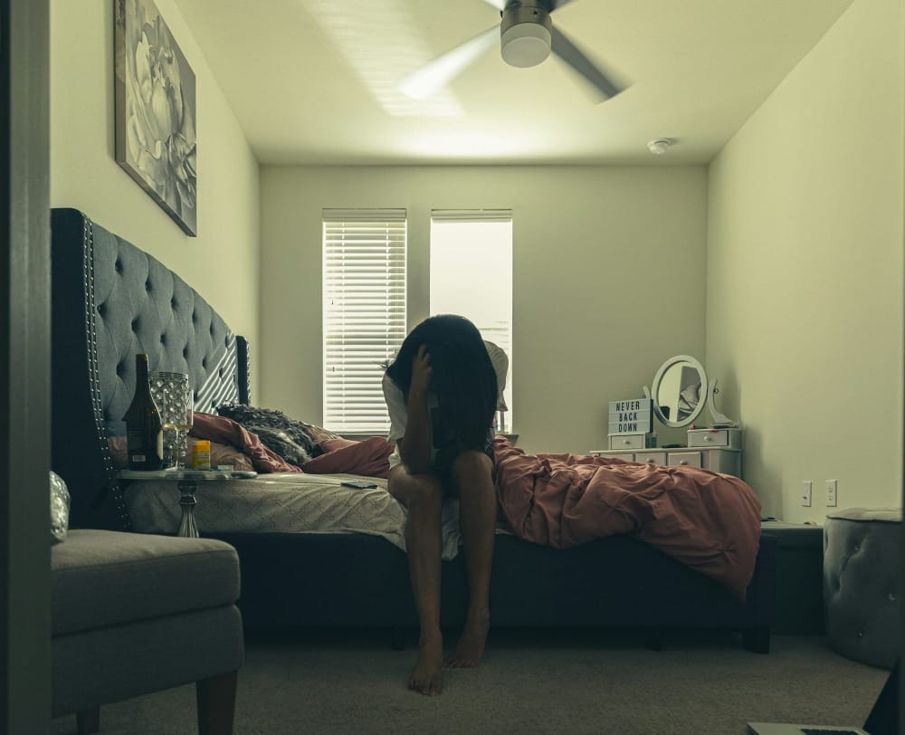 woman in black t-shirt and black shorts standing on black area rug