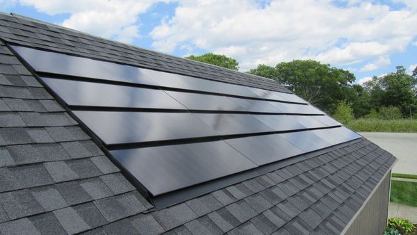 CertainTeed integrated solar shingles installed with asphalt shingles on a residential roof