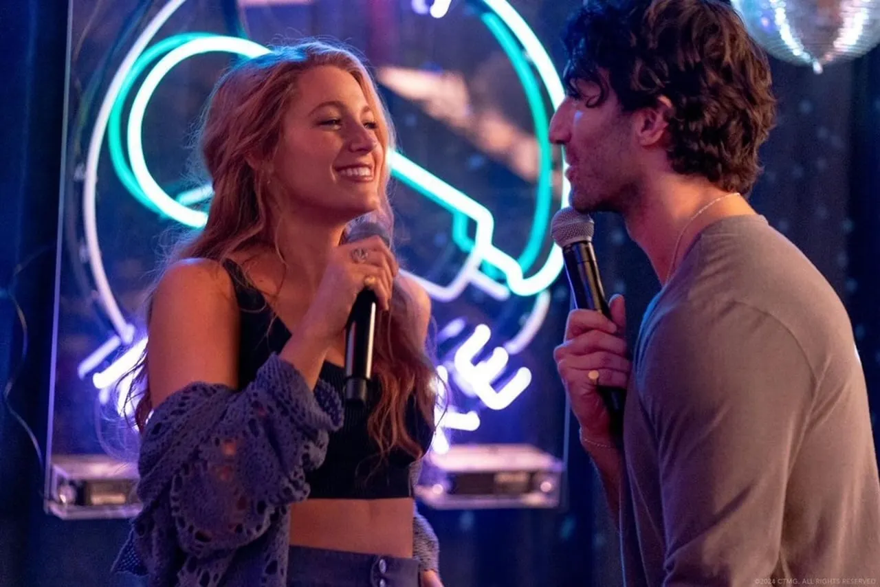 Blake Lively and Justin Baldoni as their characters Lily Bloom and Ryle Kincaid in It Ends With Us, they are smiling at each