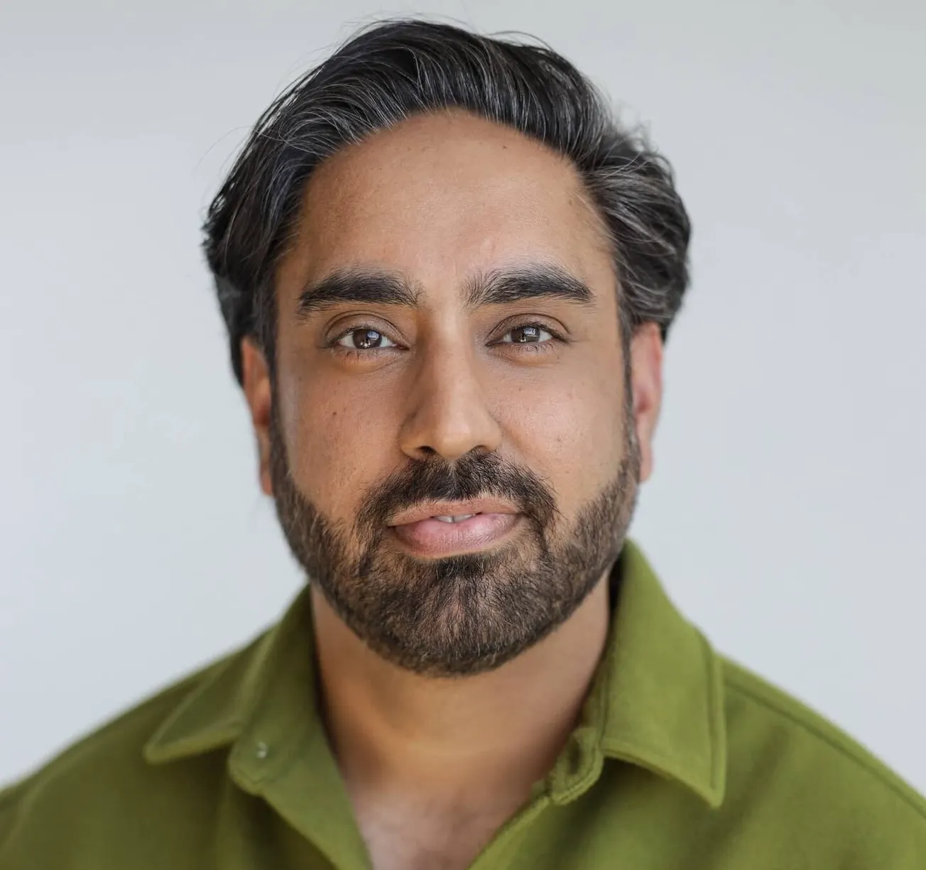 Bali Padda, a headshot. He is an Indian man with dark hair and facial hair, wearing a khaki shirt.