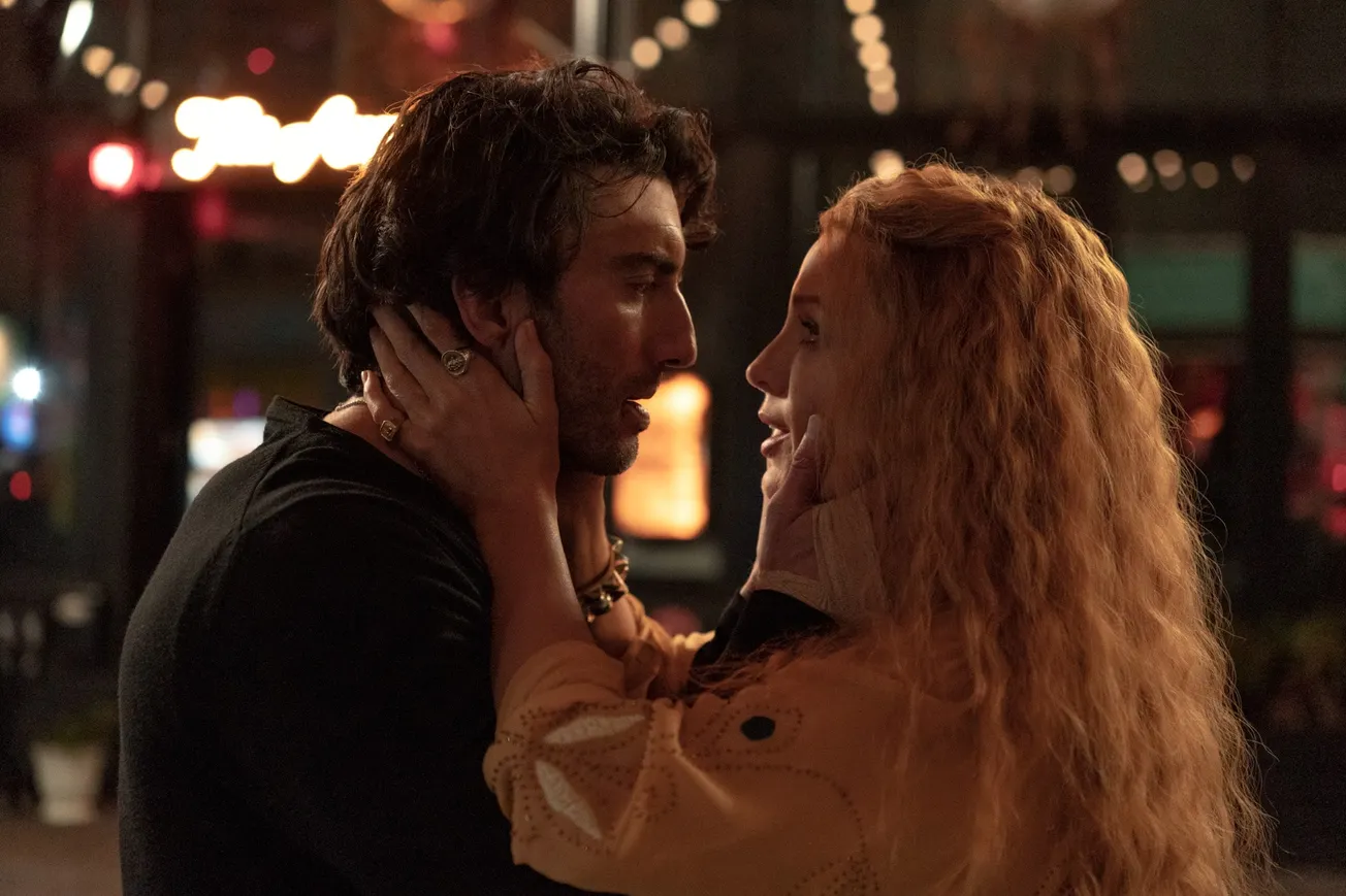 A still from It Ends With us showing Justin Baldoni's Blake Lively's character Lily looking at each other intensely