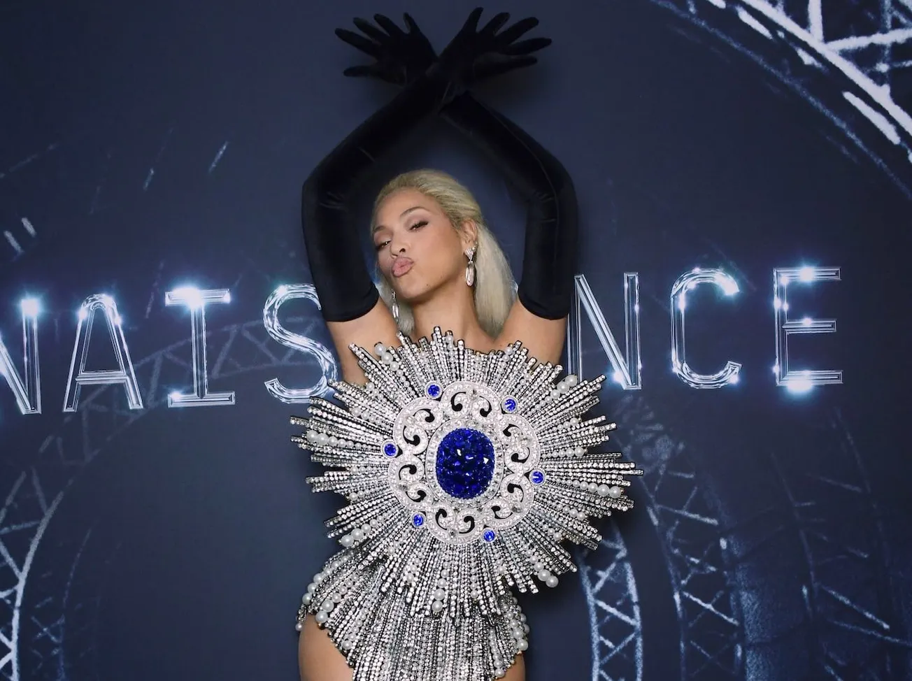 Beyonce with her arms up and posing on the dark carpet for her 'Renaissance' film premiere