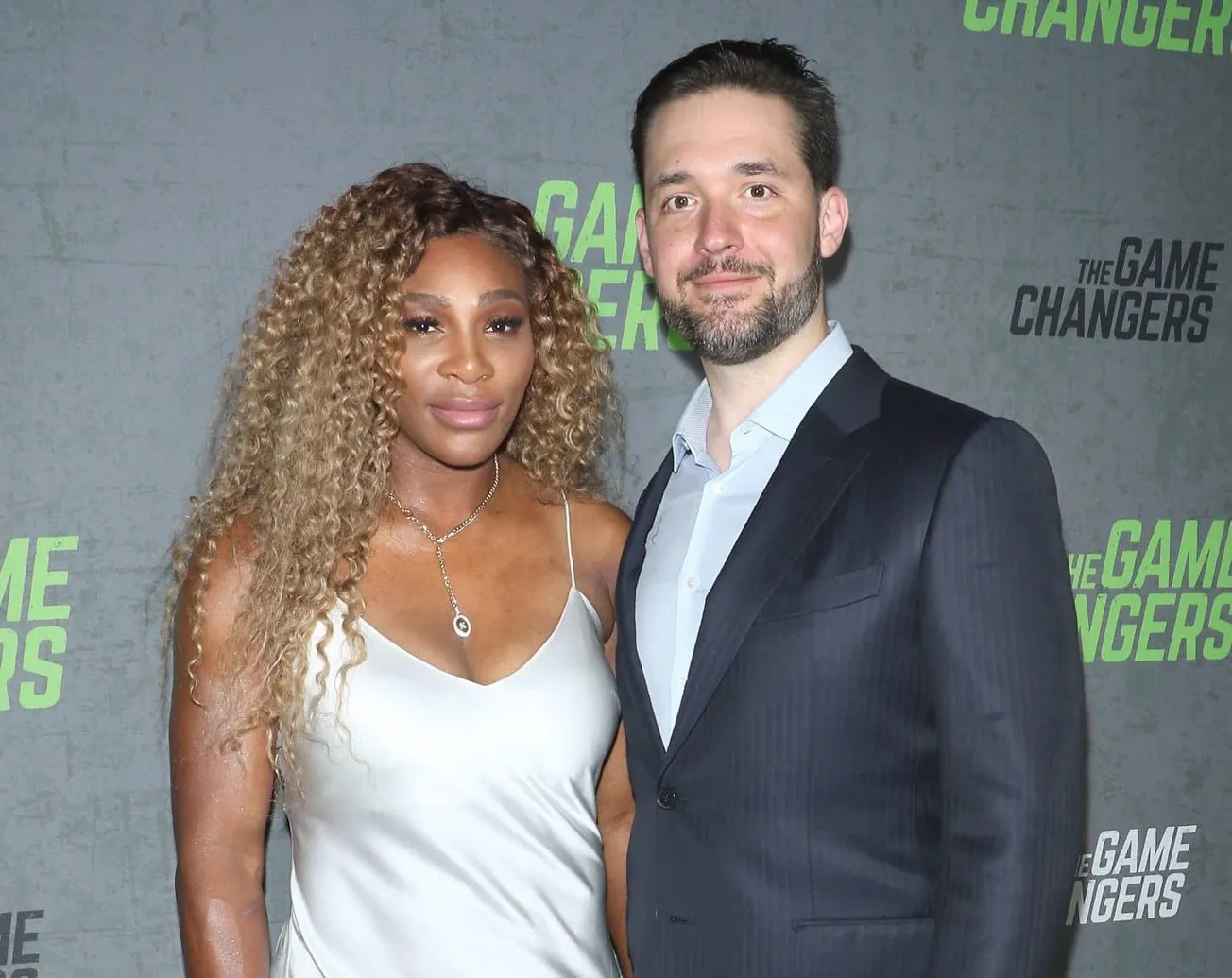 Serena Williams and Alexis Ohanian smile together at a press event. Today they've announced the birth of Adira River Ohanian.