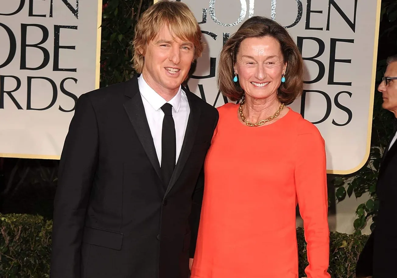 Owen Wilson with his mother Laura Wilson at the 69th Annual Golden Globe Awards. He's dressed in a suit and has shaggy blonde
