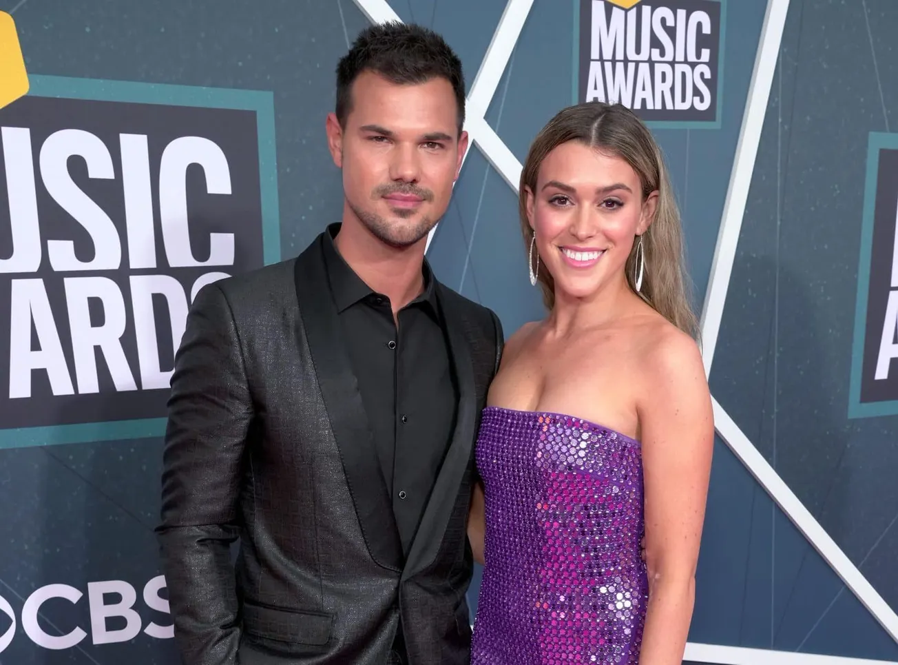 Taylor Lautner and Taylor Lautner smile together at the CMTAwards