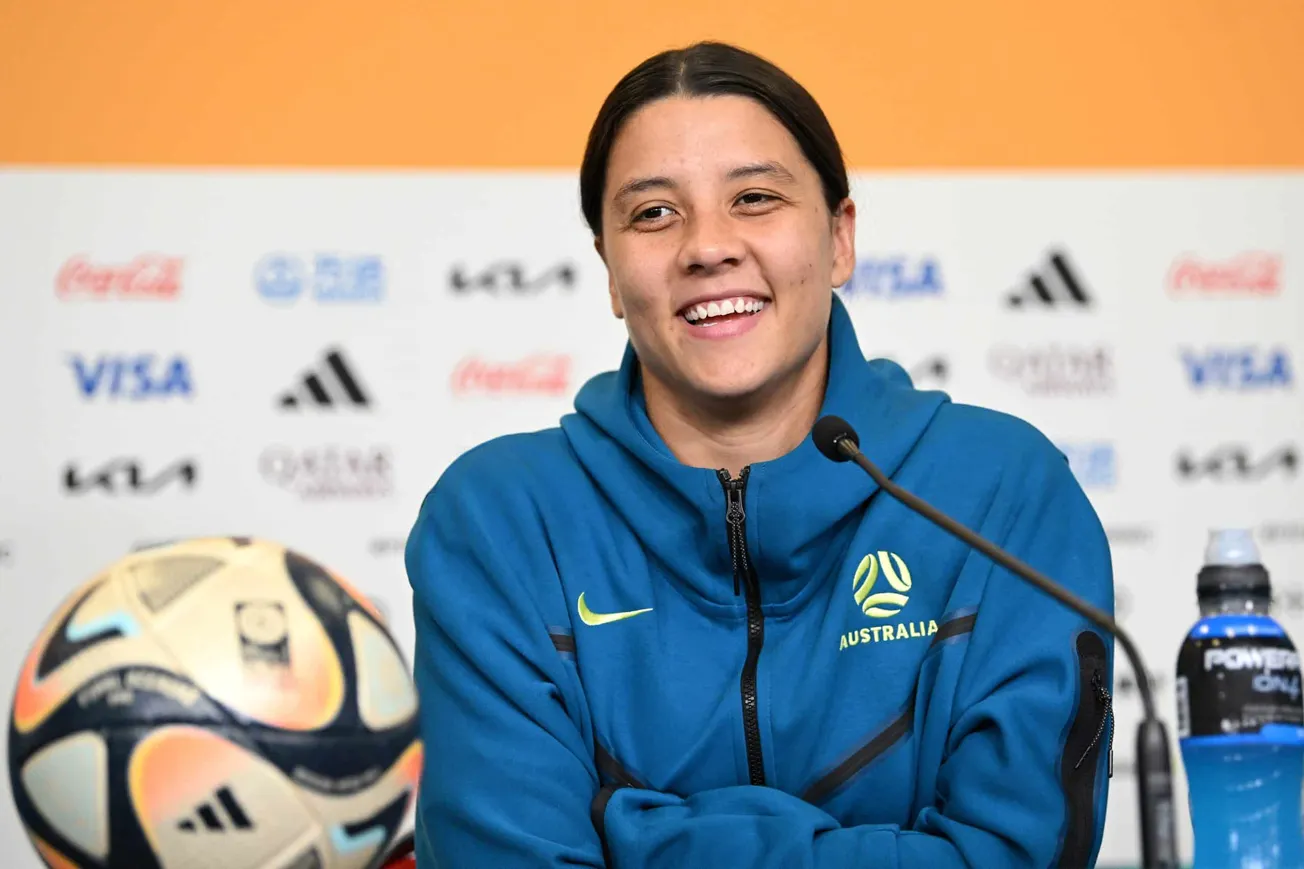 Sam Kerr smiles at a press event during the FIFA world cup 2023. Today she's announced the launch of her football academy for