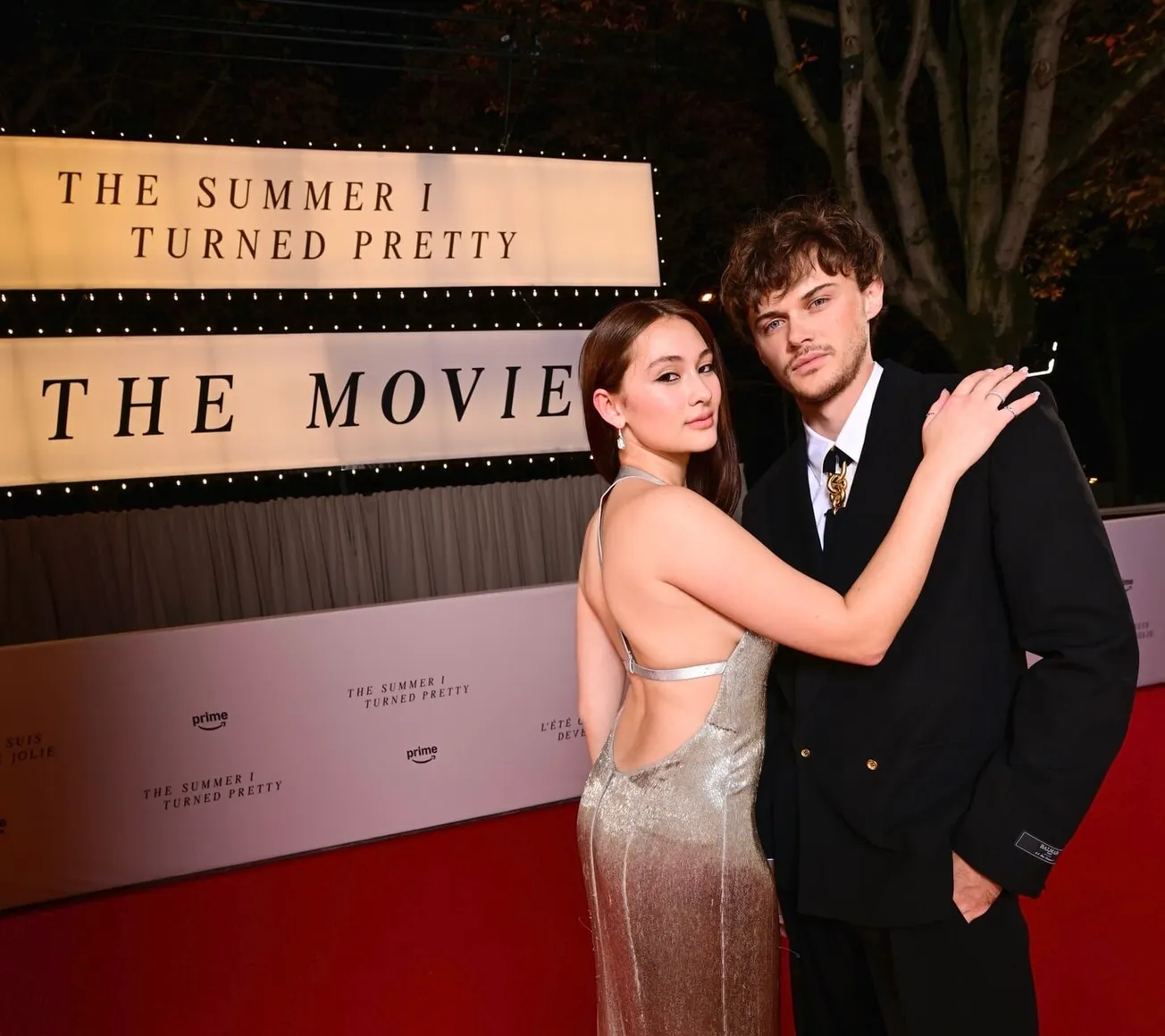 Lola Tung and Chris Briney at the season 3 finale premiere of 'The Summer I Turned Pretty' with a sign behind them announcing