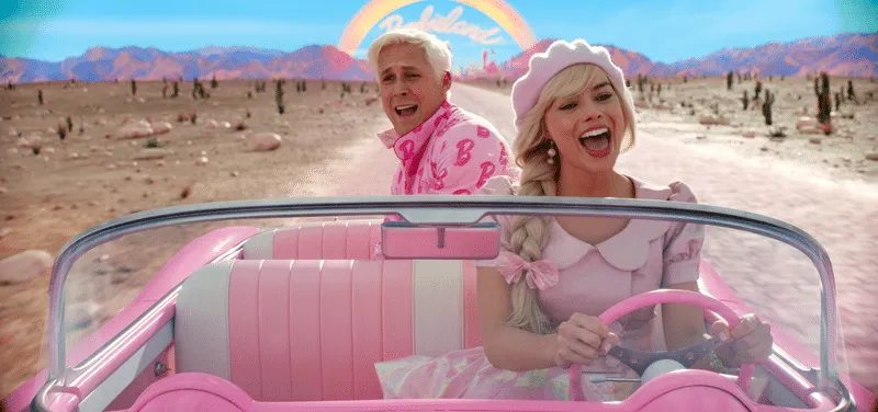 Golden globe nominated Margot Robbie's Barbie and Ryan Gosling's Ken sit in a pink convertible with a rainbow behind them. Th