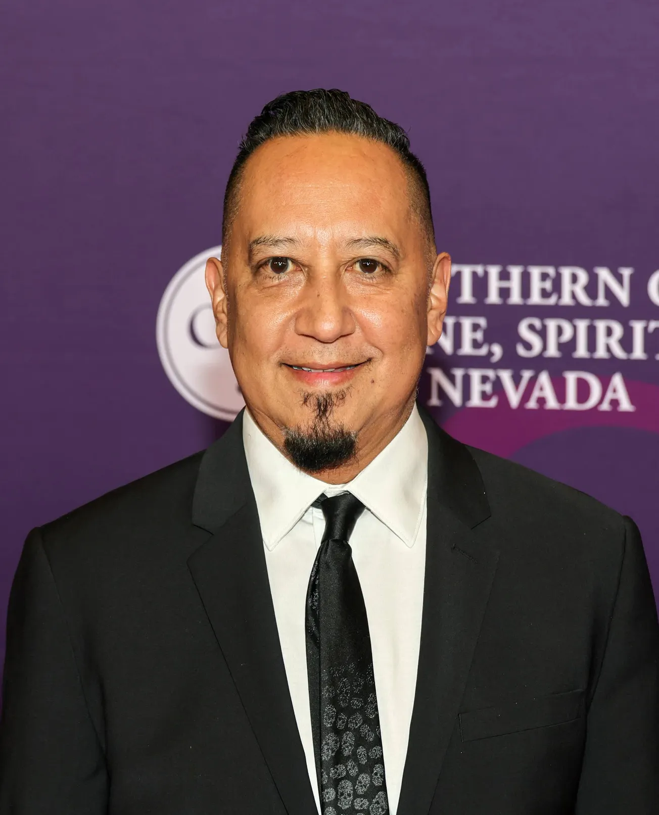 Cleto Escobedo III smiling at a press event