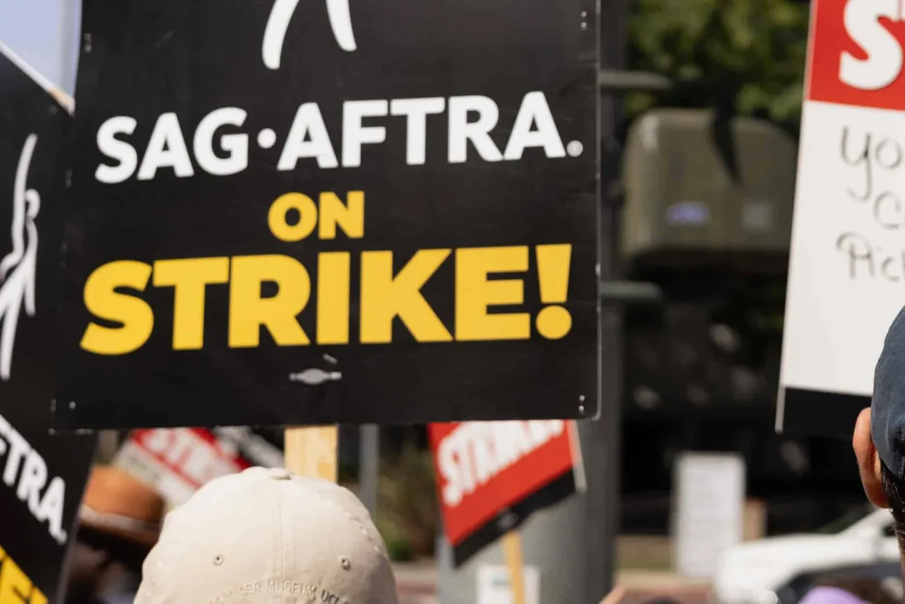 Actors holding strike signs outside studios.