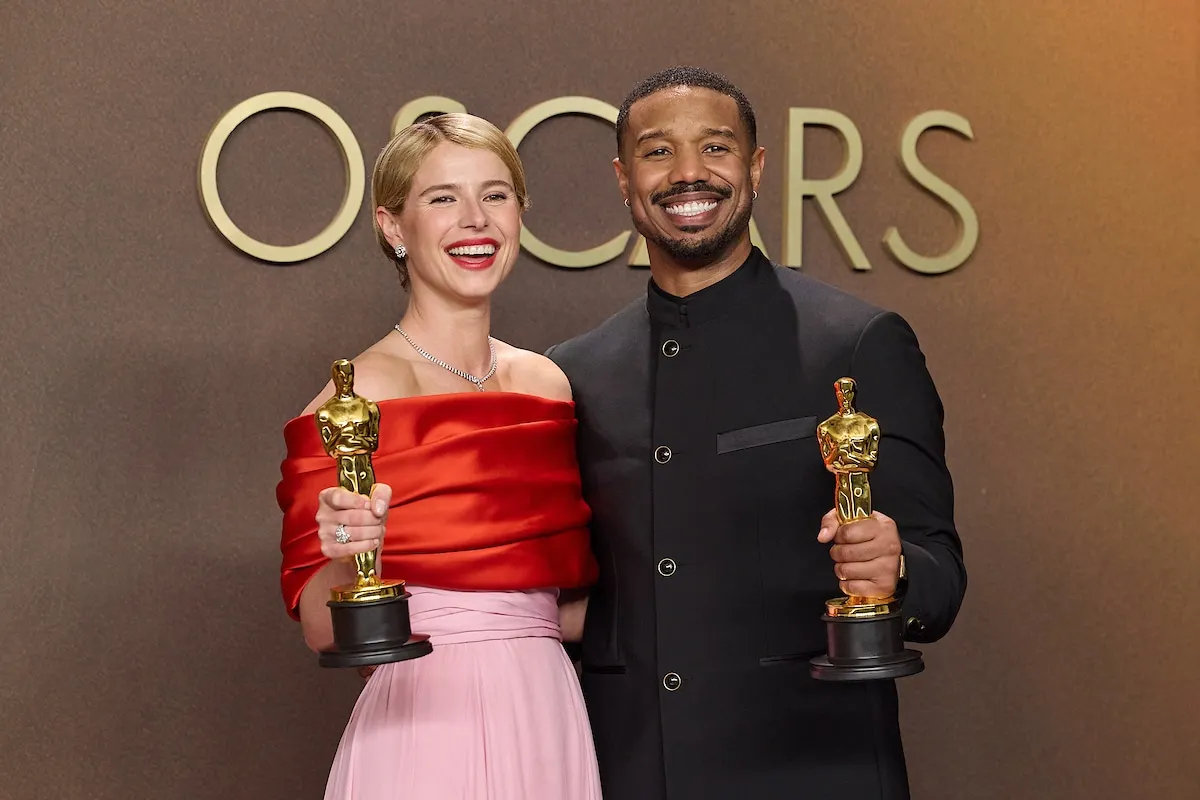 Oscar winners Jessie Buckley and Michael B. Jordan hold their statuettes and smile together