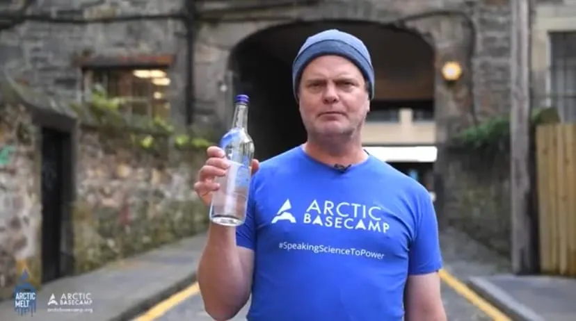 Rainn Wilson Holds Bottled Melted Iceberg to Highlight Urgent Climate Action Needed at COP26