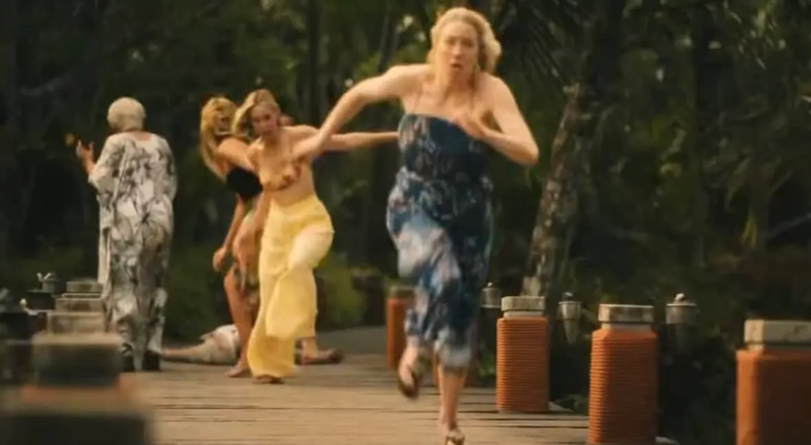Carrie Coon in a still from The White Lotus' final episode, sprinting away from the drama