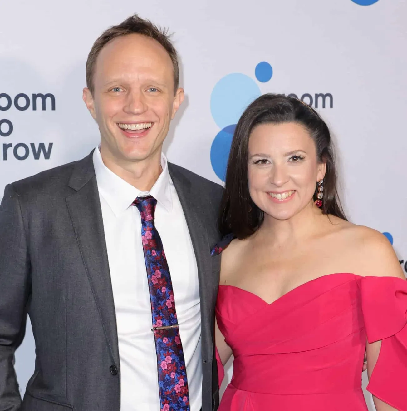 Aron Accurso and Ms. Rachel smile together at a red carpet event