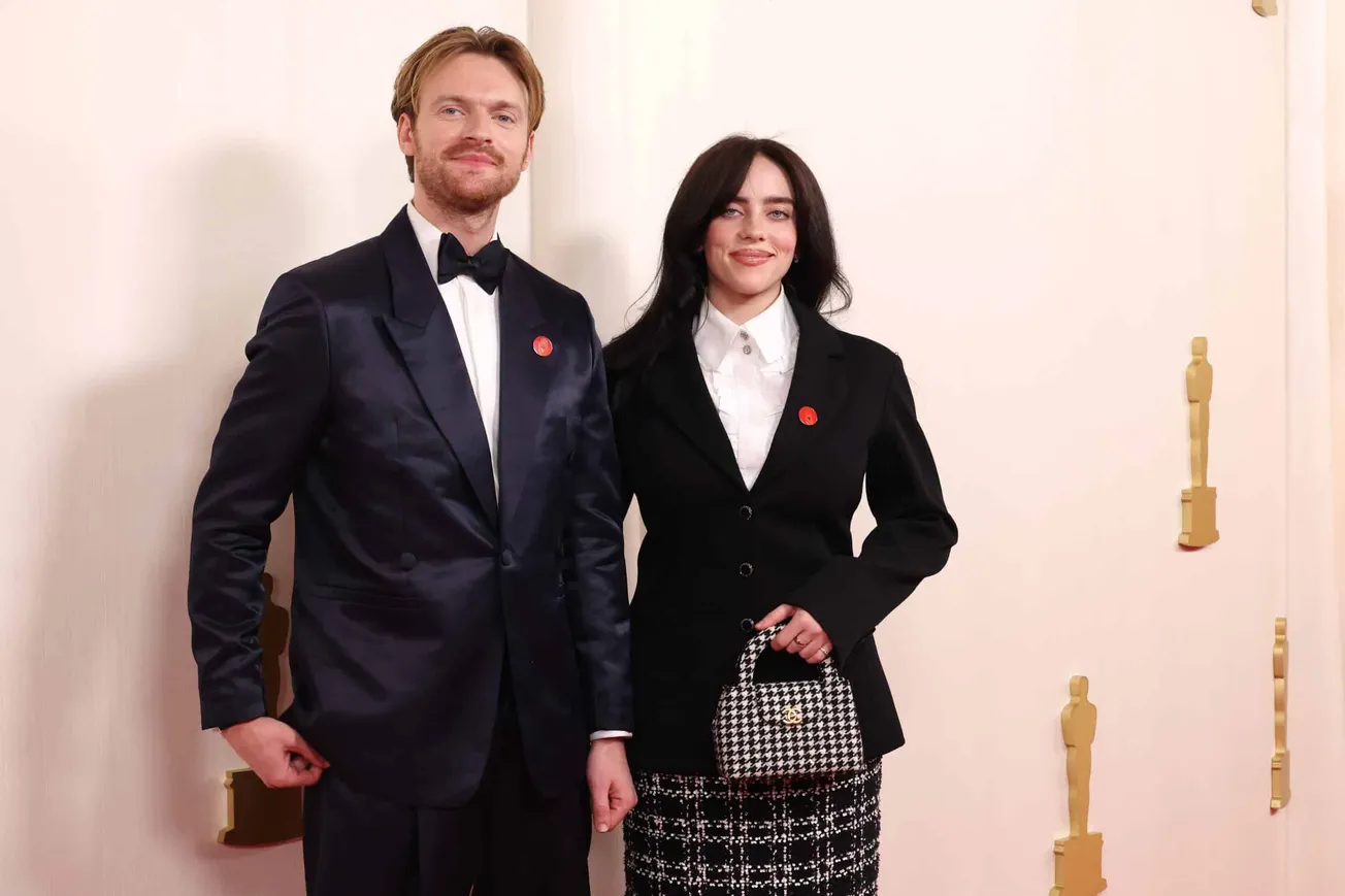 Finneas and Billie Eilish attend the Oscars wearing a red pin which is calling for a ceasefire in Gaza.