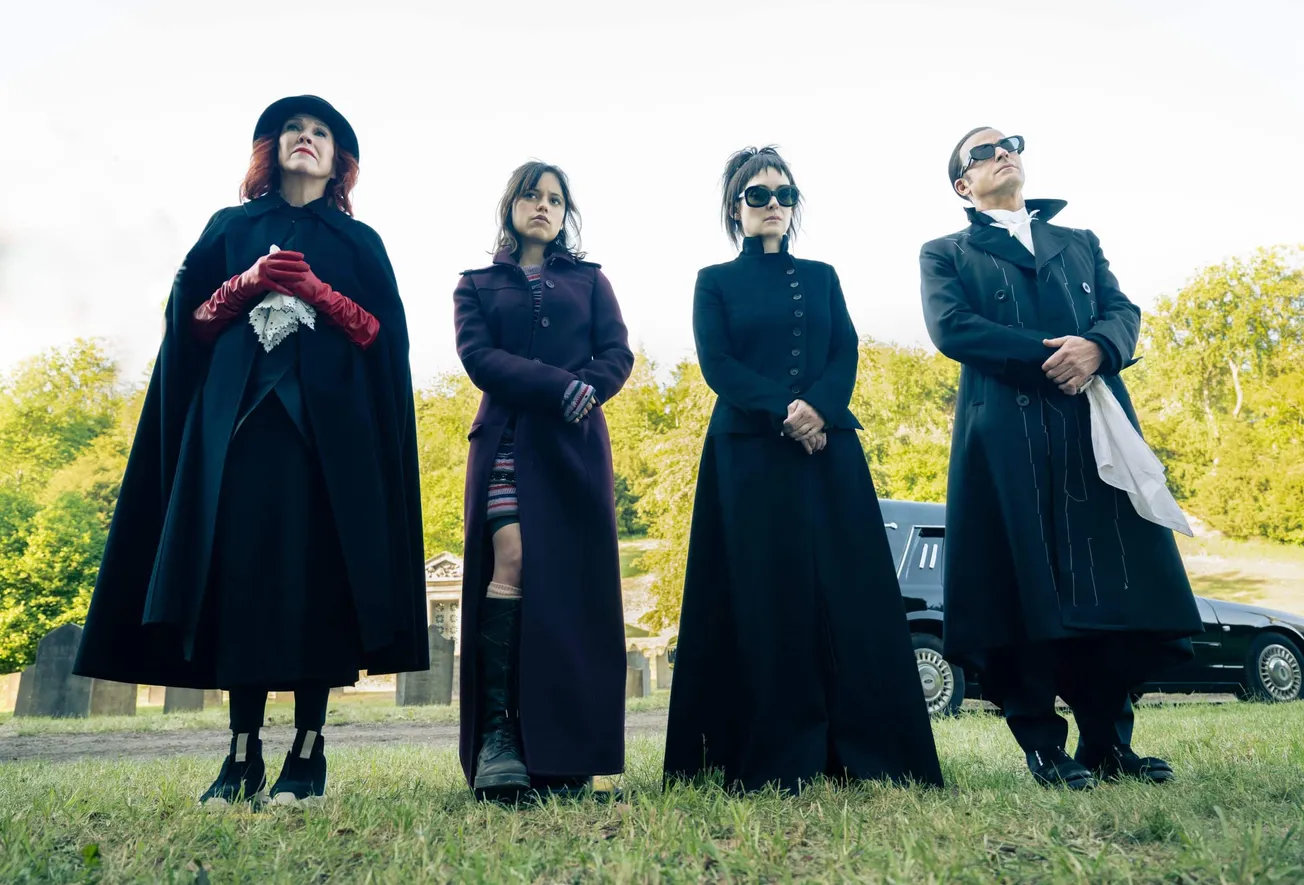 A still from Beetlejuice 2 featuring Catherine O'Hara, Jenna Ortega, Winona Ryder and Justin Theroux all dressed in black and