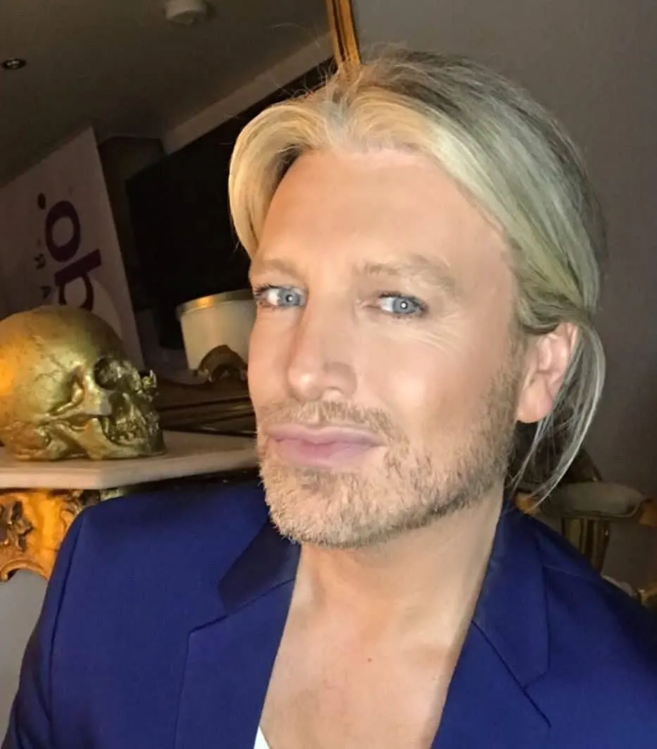 Wig stylist Kyle Kneath smiles for a photo