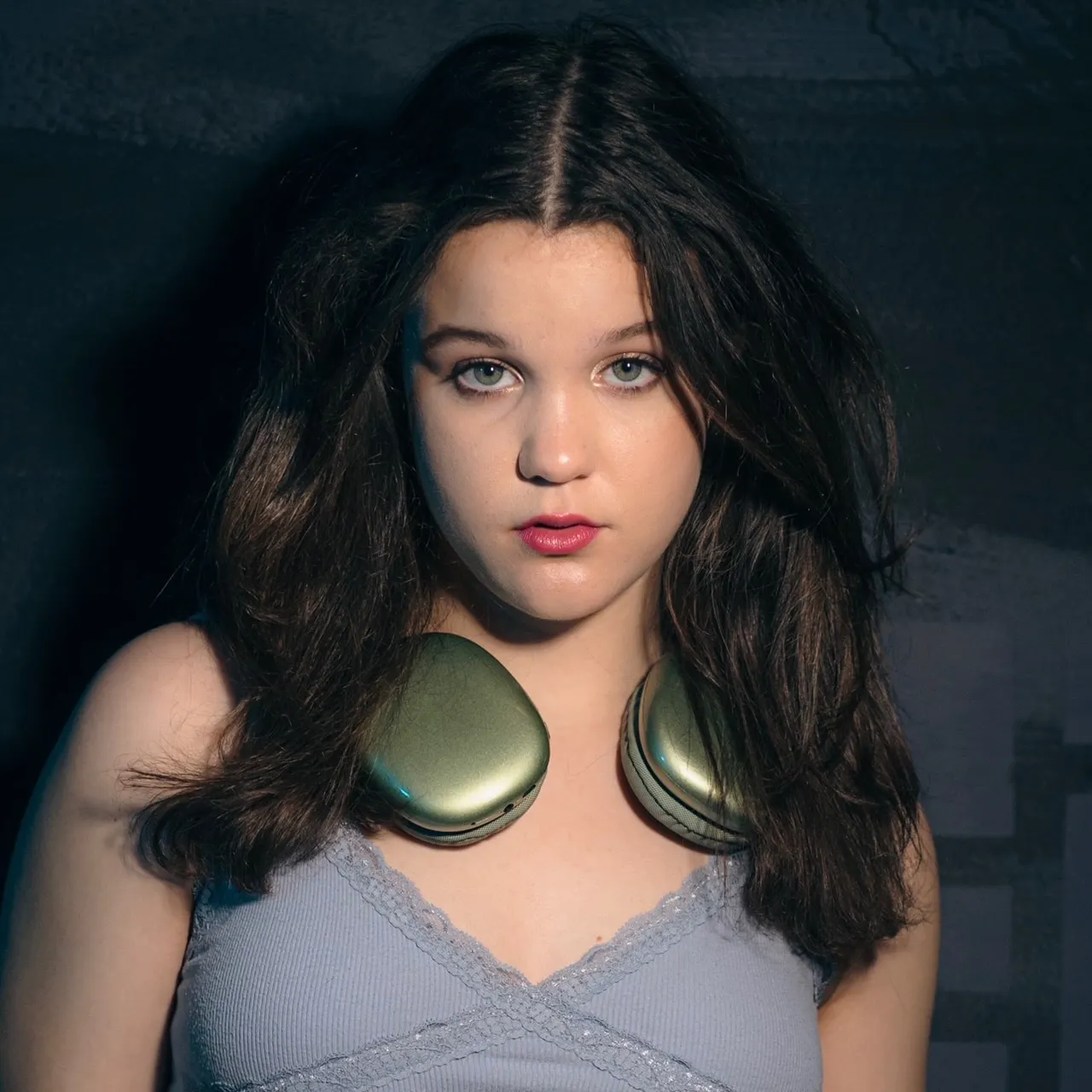 Anna Goldsmith stares at the camera with headphones around her neck. She has just released her new single "Go"