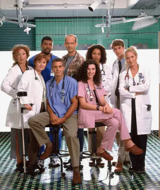 The cast of ER dressed in their scrubs and lab coats.