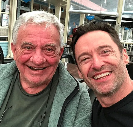 Christopher Jackman and Hugh Jackman smile for a selfie.